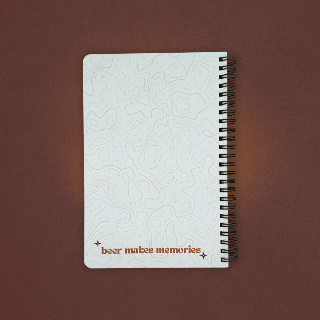 Notebook with embossed design and 'beer makes memories' text on a brown background