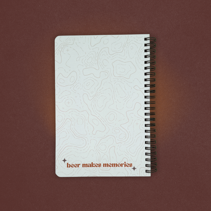Notebook with embossed design and 'beer makes memories' text on a brown background
