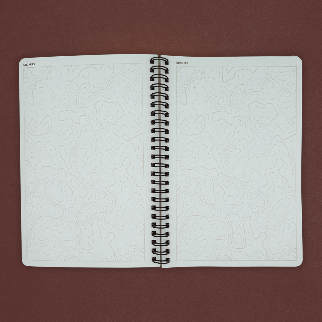 Open notebook with embossed pages on a brown background