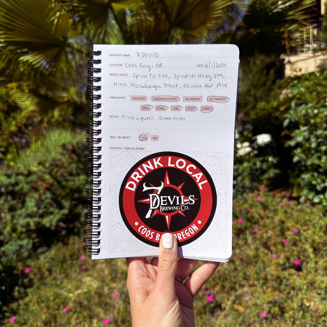 Passpourt brewery journal with 7 Devils Brewing sticker held in front of a natural background